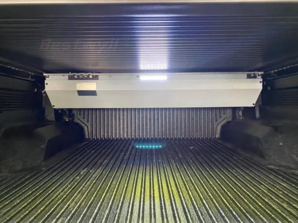Remote controlled retractable truck bed cover with light