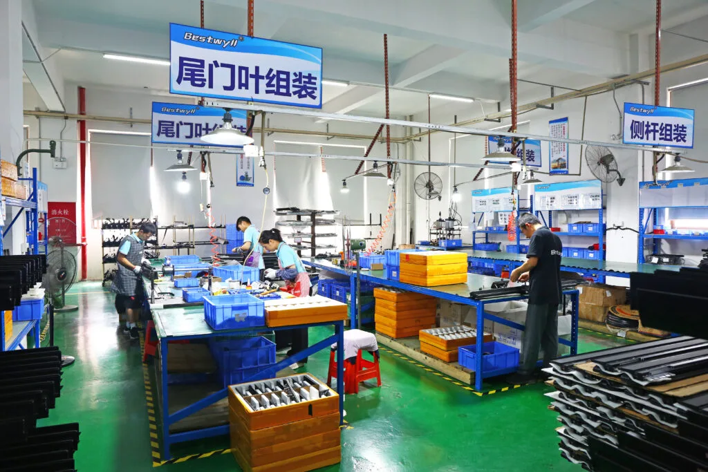 Workers assembling truck bed covers